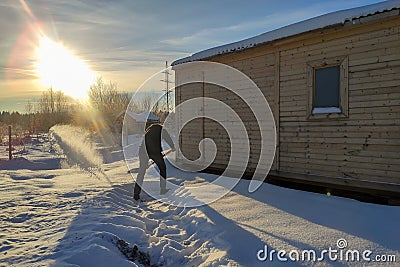 a man clears snow with a shovel Stock Photo