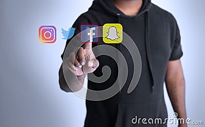 Man clicking on social media icons Editorial Stock Photo