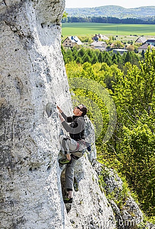 Man climbing natural rocky wall. Stock Photo