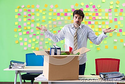 Man collecting his stuff after redundancy in the office with man Stock Photo