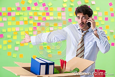 Man collecting his stuff after redundancy in the office with man Stock Photo