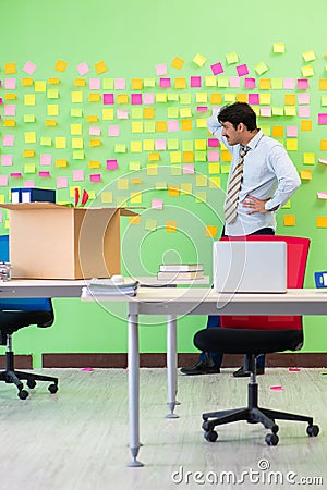 Man collecting his stuff after redundancy in the office with man Stock Photo