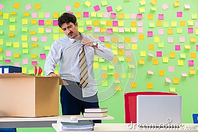 Man collecting his stuff after redundancy in the office with man Stock Photo