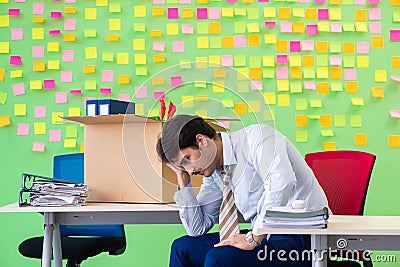 Man collecting his stuff after redundancy in the office with man Stock Photo