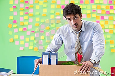 Man collecting his stuff after redundancy in the office with man Stock Photo