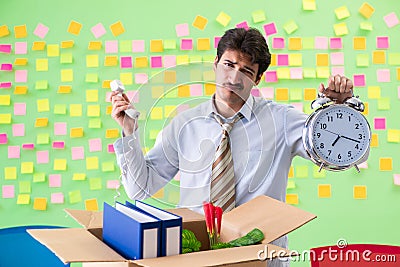 Man collecting his stuff after redundancy in the office with man Stock Photo