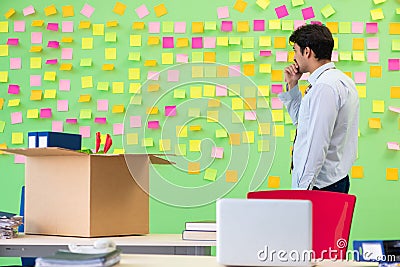 Man collecting his stuff after redundancy in the office with man Stock Photo