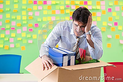 Man collecting his stuff after redundancy in the office with man Stock Photo