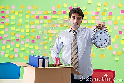 Man collecting his stuff after redundancy in the office with man Stock Photo