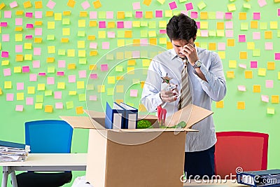 Man collecting his stuff after redundancy in the office with man Stock Photo