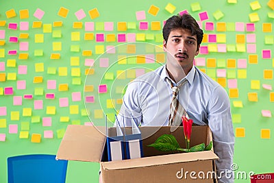 Man collecting his stuff after redundancy in the office with man Stock Photo