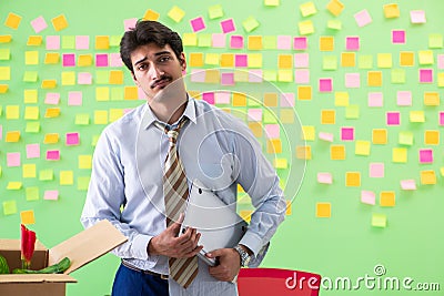 Man collecting his stuff after redundancy in the office with man Stock Photo