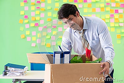 Man collecting his stuff after redundancy in the office with man Stock Photo