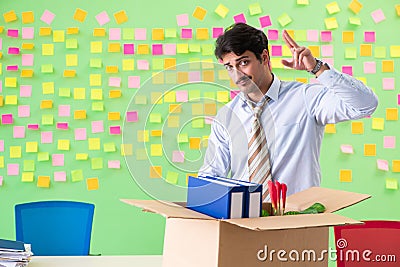 Man collecting his stuff after redundancy in the office with man Stock Photo