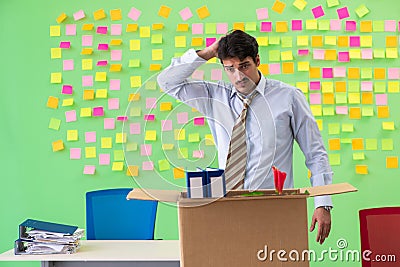 Man collecting his stuff after redundancy in the office with man Stock Photo