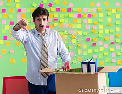 Man collecting his stuff after redundancy in the office with man Stock Photo