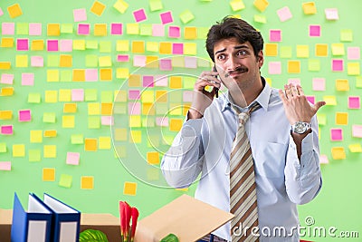 The man collecting his stuff after redundancy in the office with many conflicting priorities Stock Photo