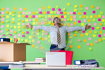 The man collecting his stuff after redundancy in the office with many conflicting priorities Stock Photo