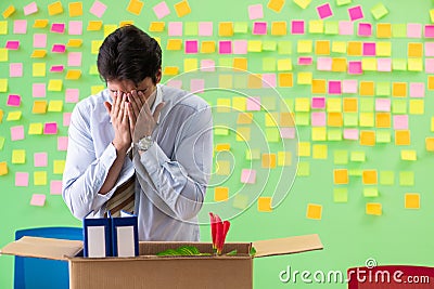 Man collecting his stuff after redundancy in the office with man Stock Photo