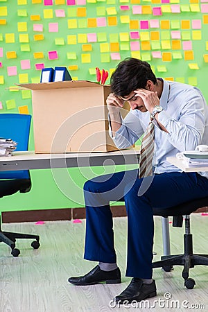 Man collecting his stuff after redundancy in the office with man Stock Photo