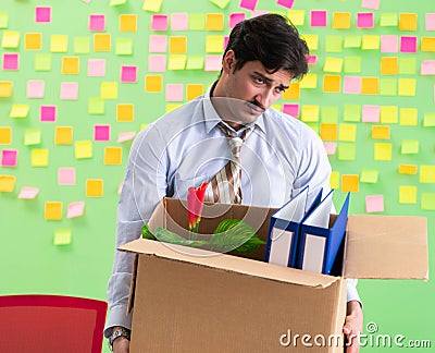 Man collecting his stuff after redundancy in the office with man Stock Photo