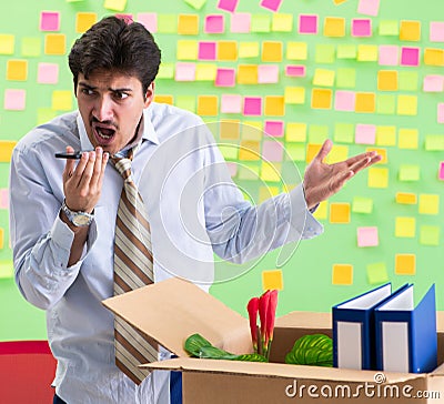 Man collecting his stuff after redundancy in the office with man Stock Photo