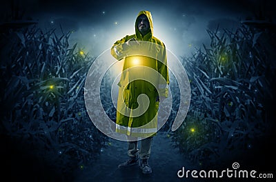 Man coming out from a thicket with lantern Stock Photo