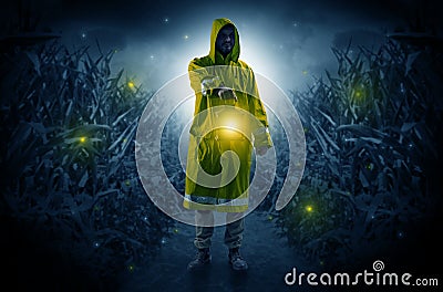 Man coming out from a thicket with lantern Stock Photo