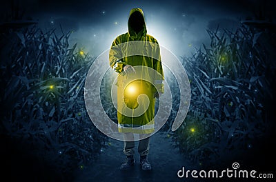 Man coming out from a thicket with lantern Stock Photo