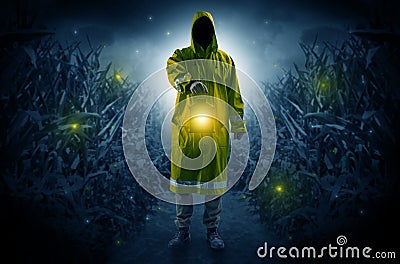 Man coming out from a thicket with lantern Stock Photo