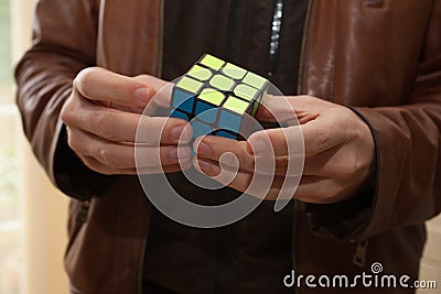 A man completing a Rubix cube Editorial Stock Photo
