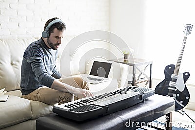 Man composing a song with electric piano Stock Photo