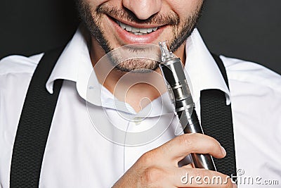 Man with concealed identity smoking a vape Stock Photo