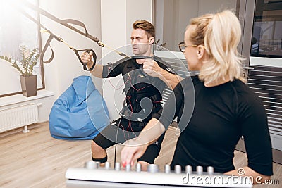 Man concentrated on training and his personal coach looking at h Stock Photo