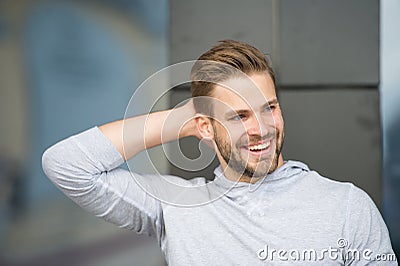 Man confident in his antiperspirant. Prevent, reduce perspiration. No sweat - deodorant works. Guy checks dry armpit Stock Photo