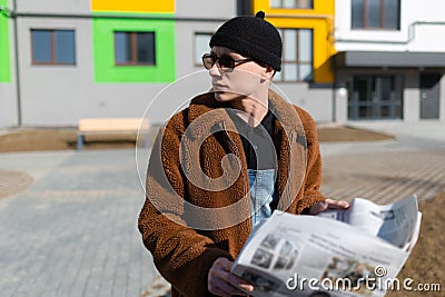 A man is considering the news he has just read in the newspaper. Stock Photo