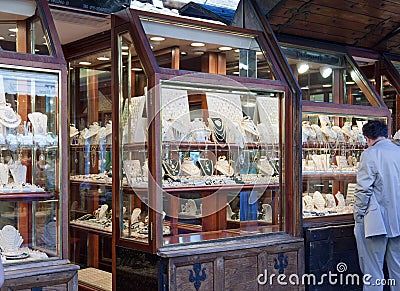 The man considers jewelry in a show-window on Ponte Vecchio. Editorial Stock Photo