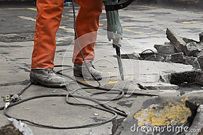 Man at construction site demolishing asphalt Stock Photo