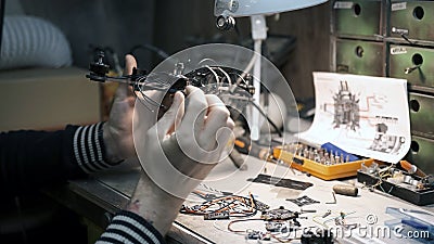 Man constructs a FPV drone from parts Stock Photo