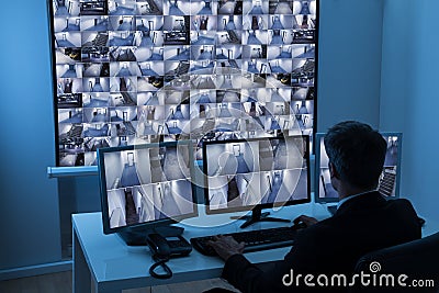 Man in control room monitoring cctv footage Stock Photo