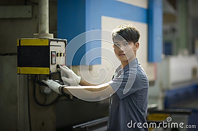 Man controlling hydraulic Press brake Stock Photo