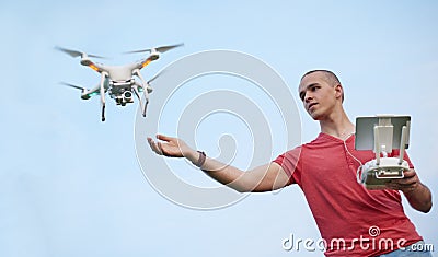 Man controls a quadrocopter in park Stock Photo