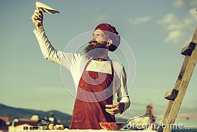 Man cook throwing dough Stock Photo