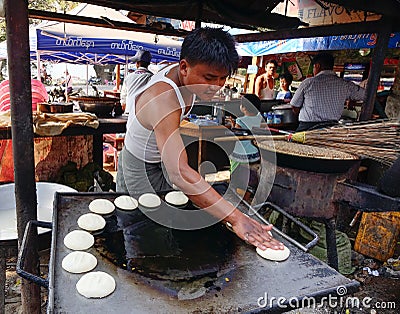 A man cooking cakes on street in Mandalay, Myanmar Editorial Stock Photo