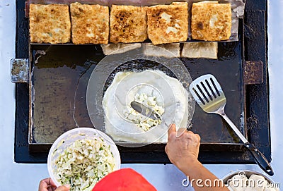 Man cooking Martabak or Stuffed Pancake Stock Photo