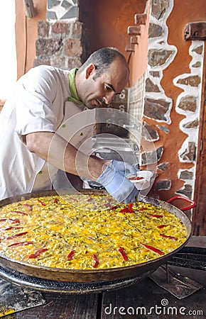 Man cooking a seafood paella Editorial Stock Photo