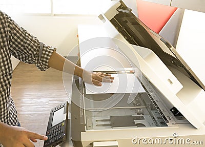 Man copying paper from Photocopier sunlight from window Stock Photo