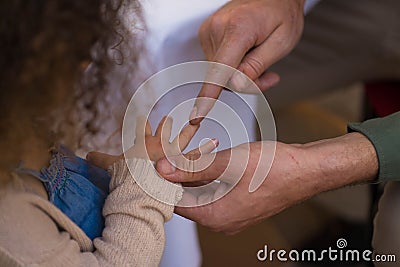 Man counts fingers on girls hand Stock Photo