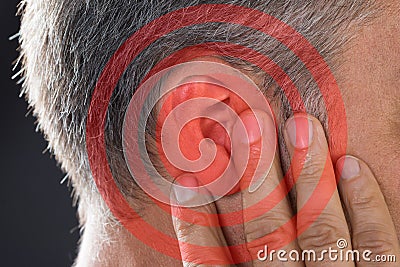 Man Covering Ear With Hand Stock Photo