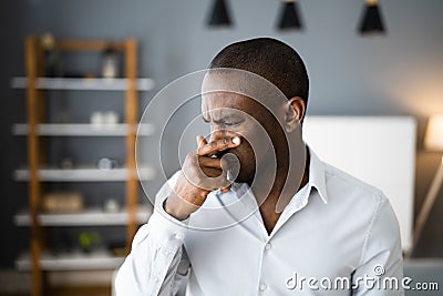 Man Covering His Nose From Bad Smell Stock Photo